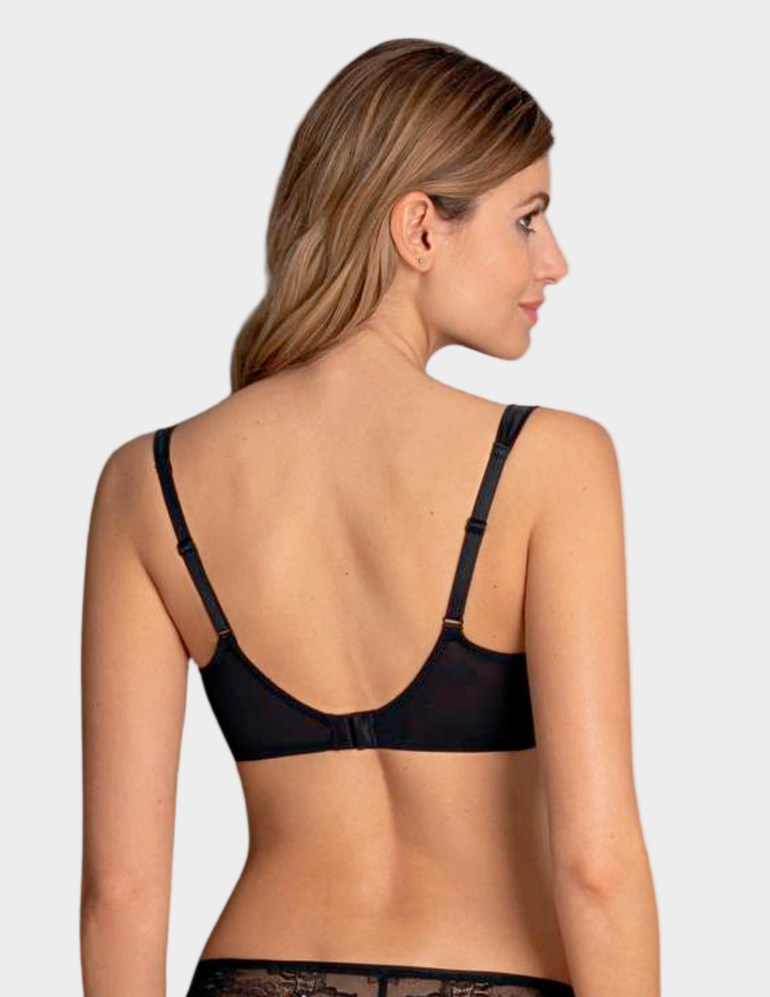 Woman wearing a black bra on a white background