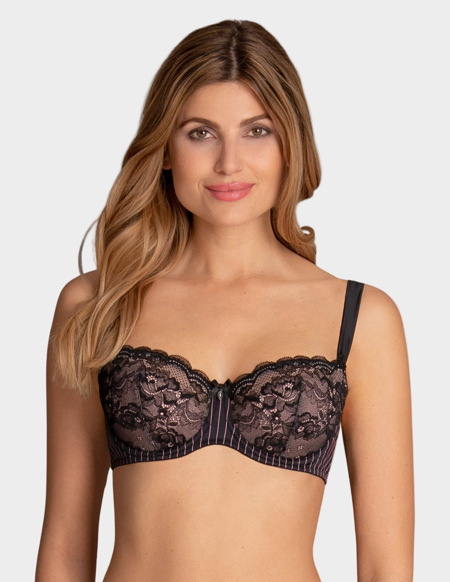 Woman wearing a black lace bra against a plain background