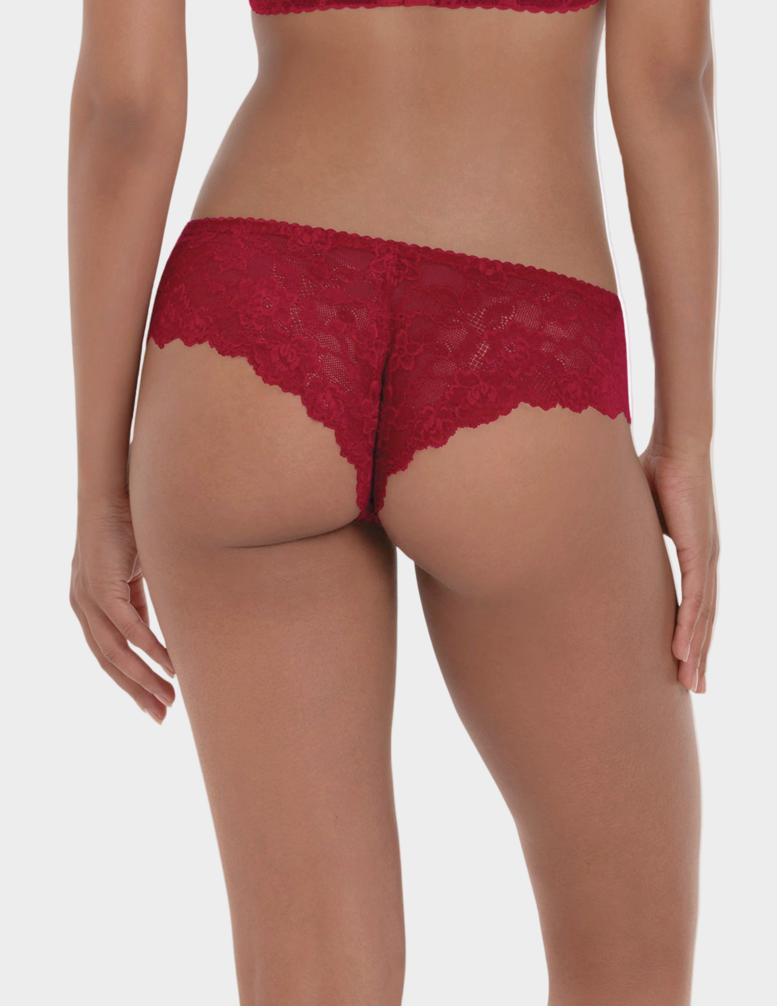 Back view of woman wearing red lace underwear on a white background