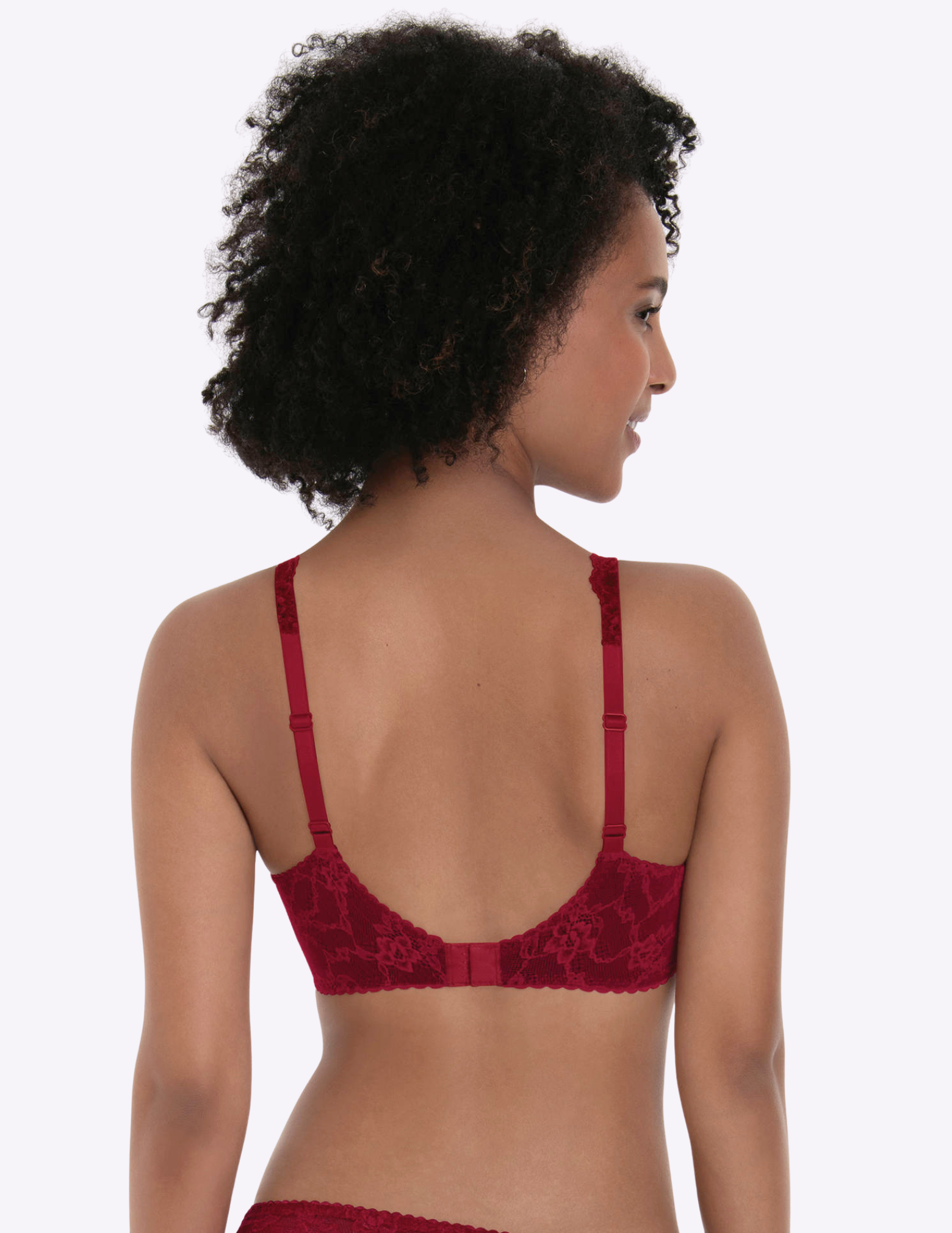 Woman wearing a red lace bra against a white background