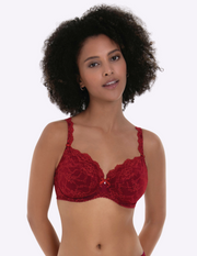 Woman wearing a red lace bra against a white background