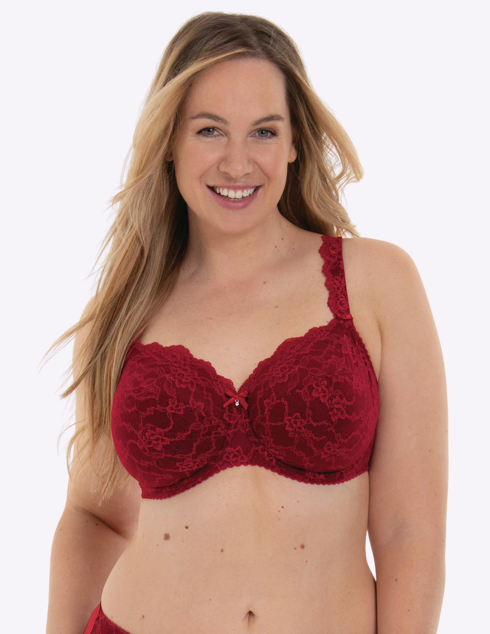 Woman wearing a red lace bra against a white background