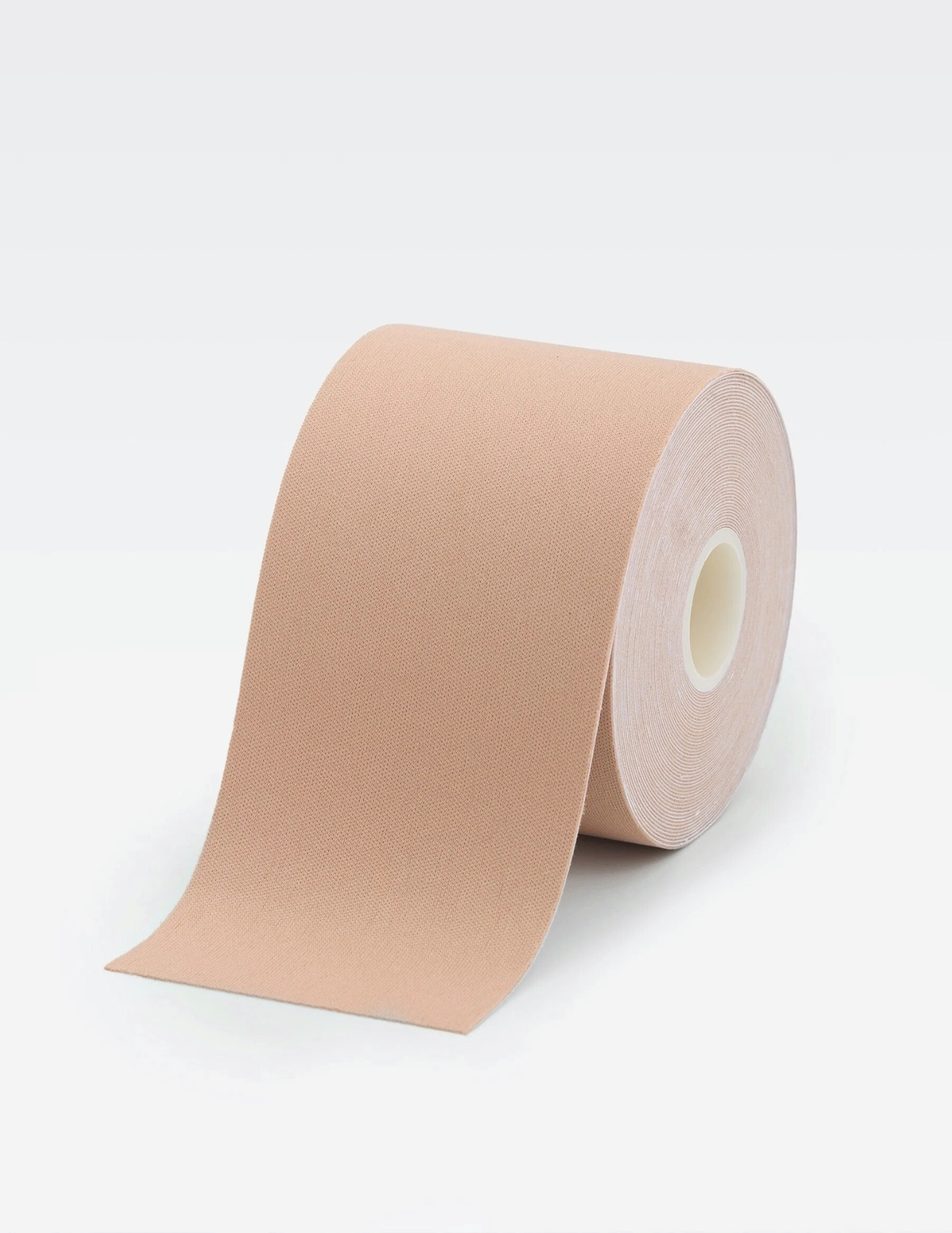 large roll of beige body tape on white background