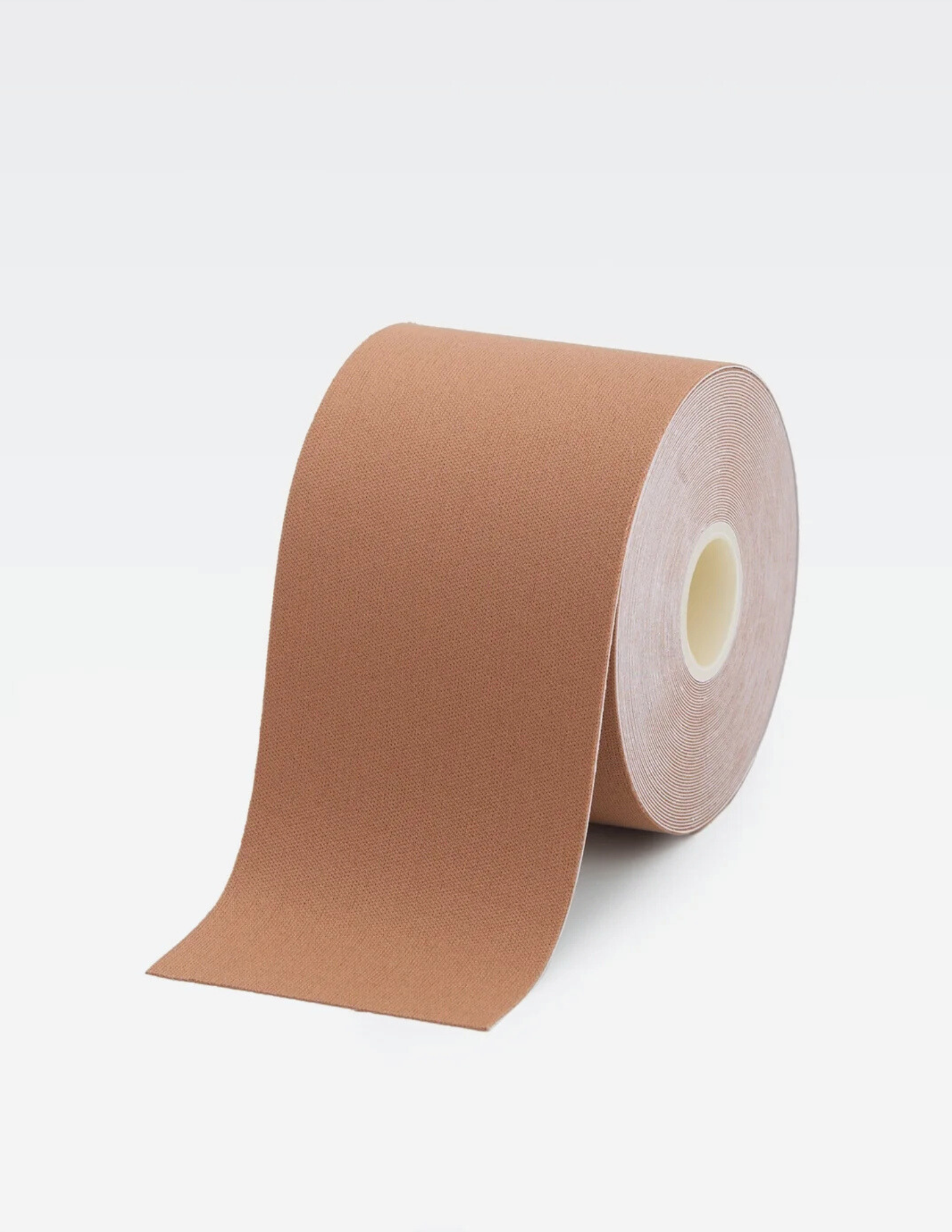 large roll of brown body tape on white background