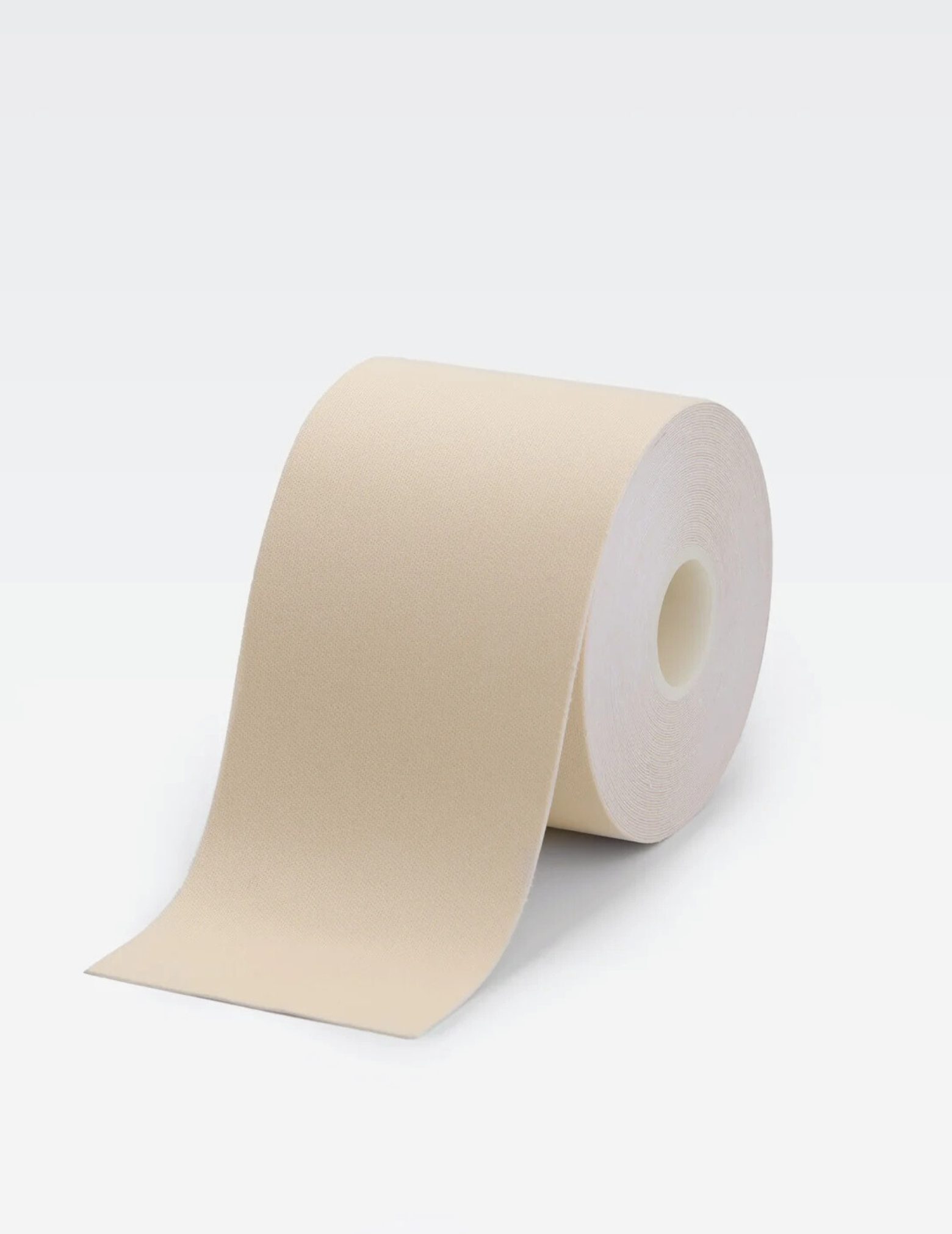 large roll of light beige body tape on white background