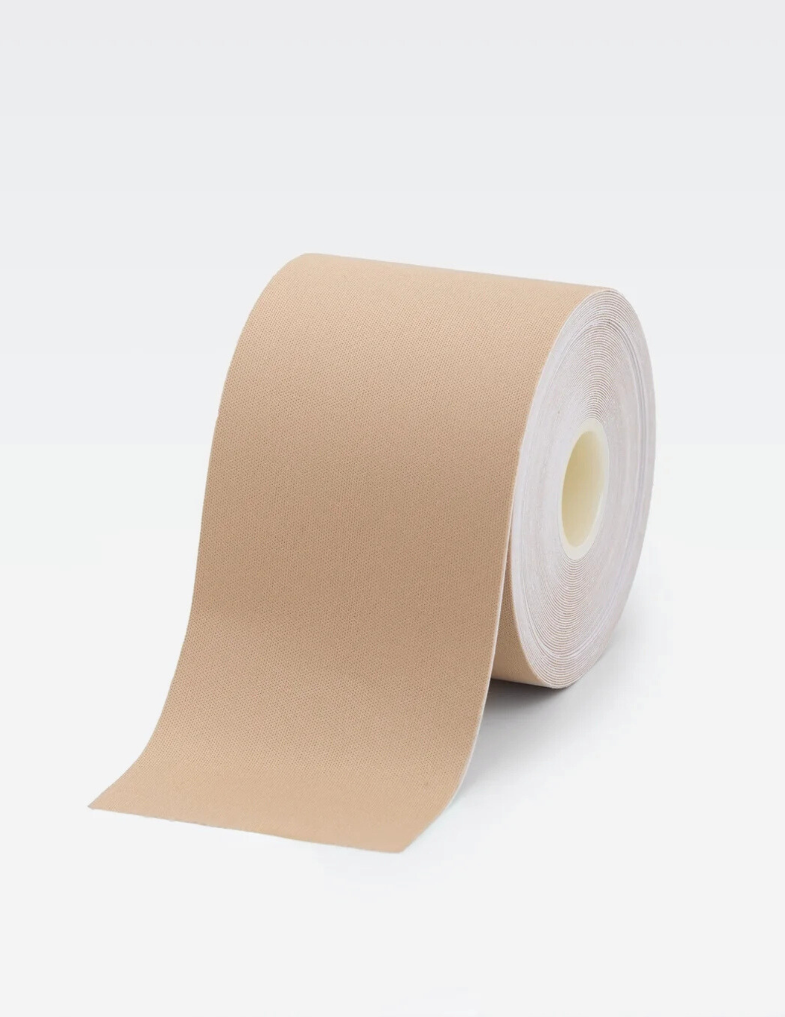 large roll of beige body tape on white background