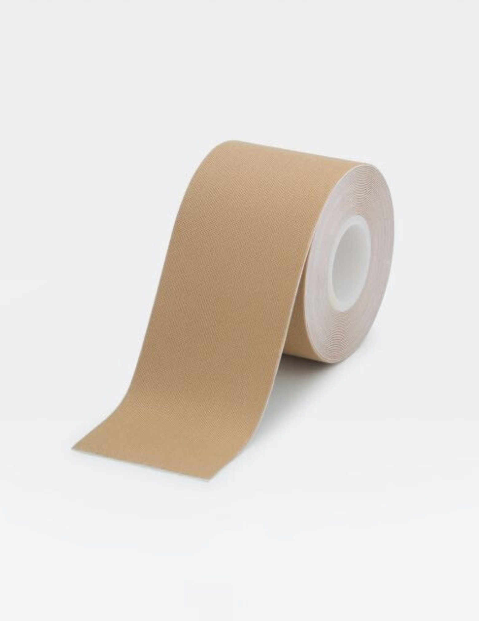 roll of beige body tape on white background