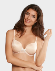 Woman wearing a beige bra on a plain background