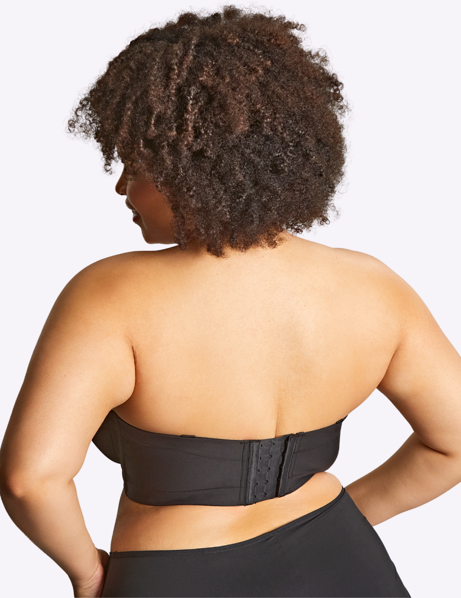 Back view of model wearing dana bra in black without straps