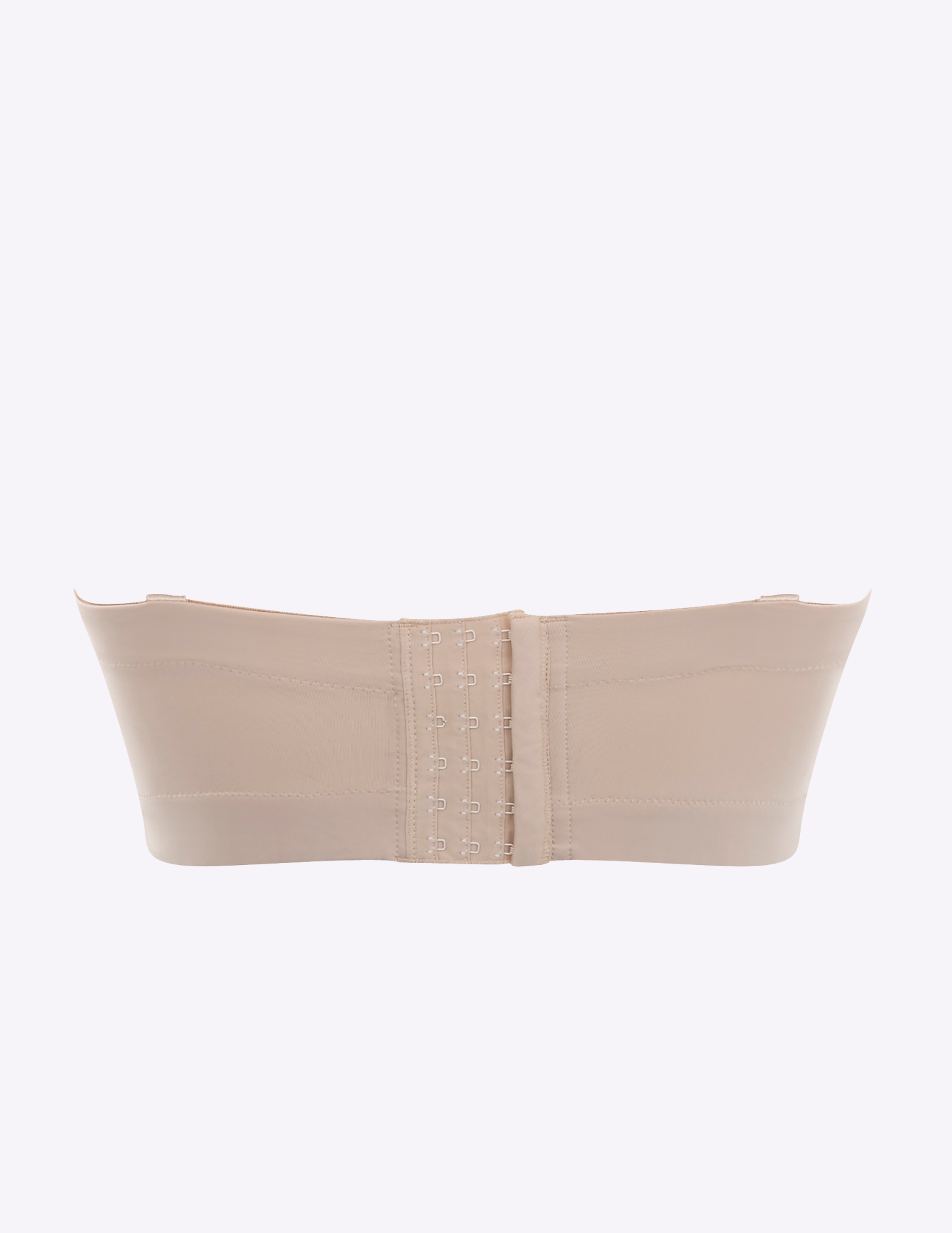 Back view of a light beige strapless bra on a white background—the closure has 6 rows of hooks
