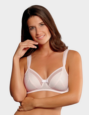Woman wearing a light pink bra against a plain background