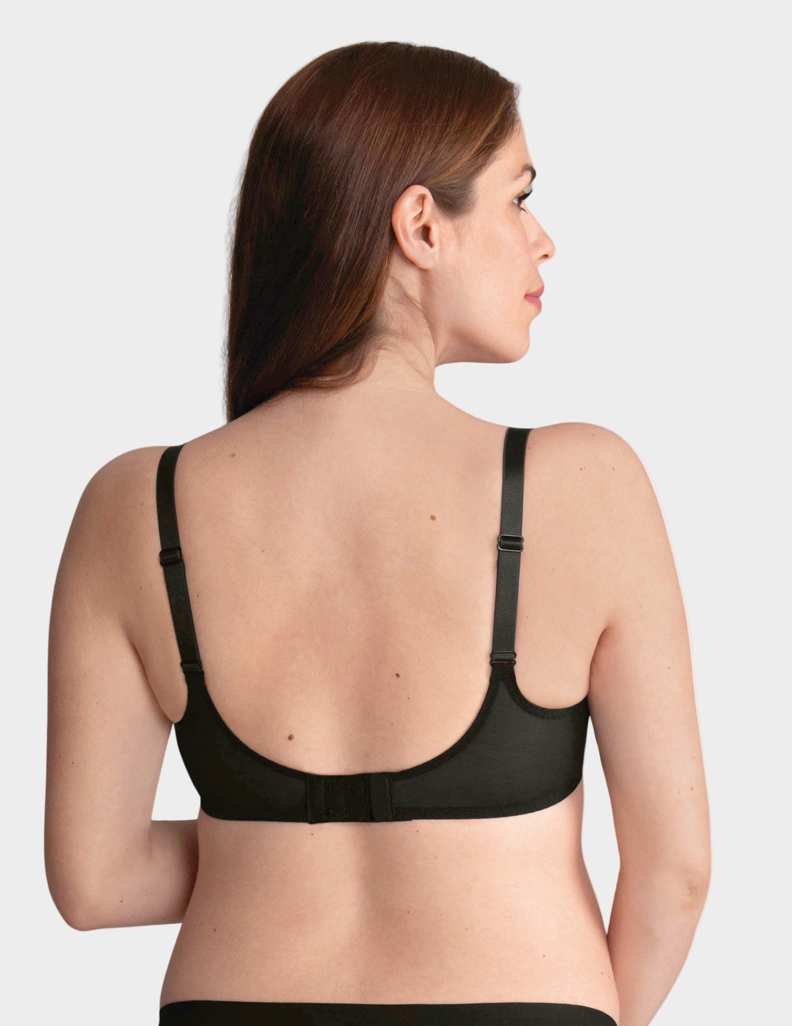 Back view of woman wearing a black bra on a white background