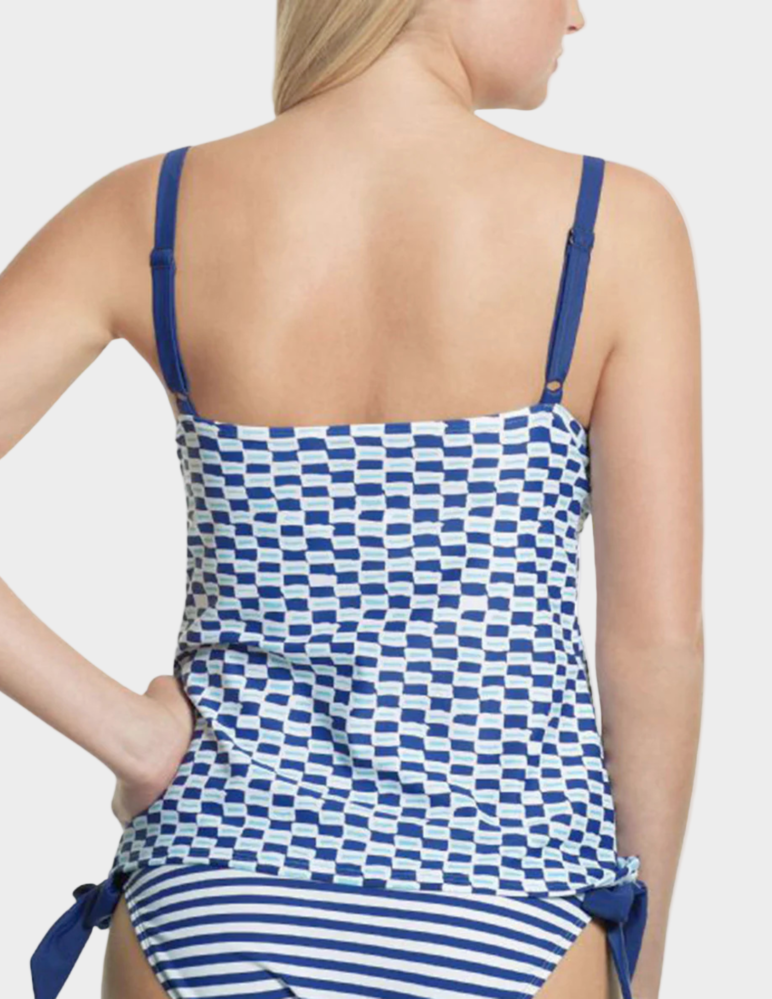 Woman wearing a blue and white patterned swimsuit on a white background