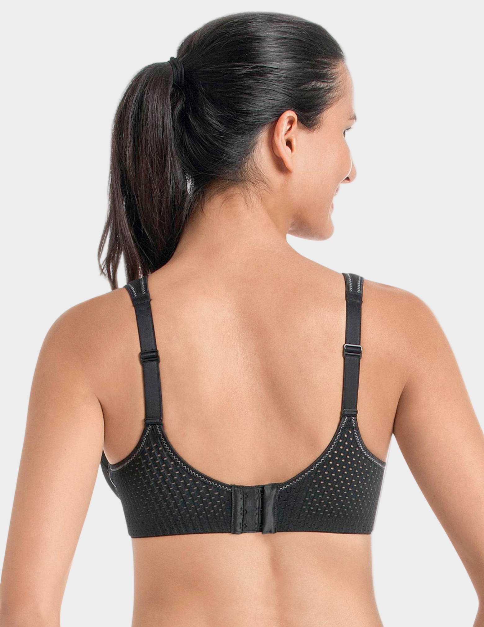 back view of Woman wearing a black sports bra on a white background