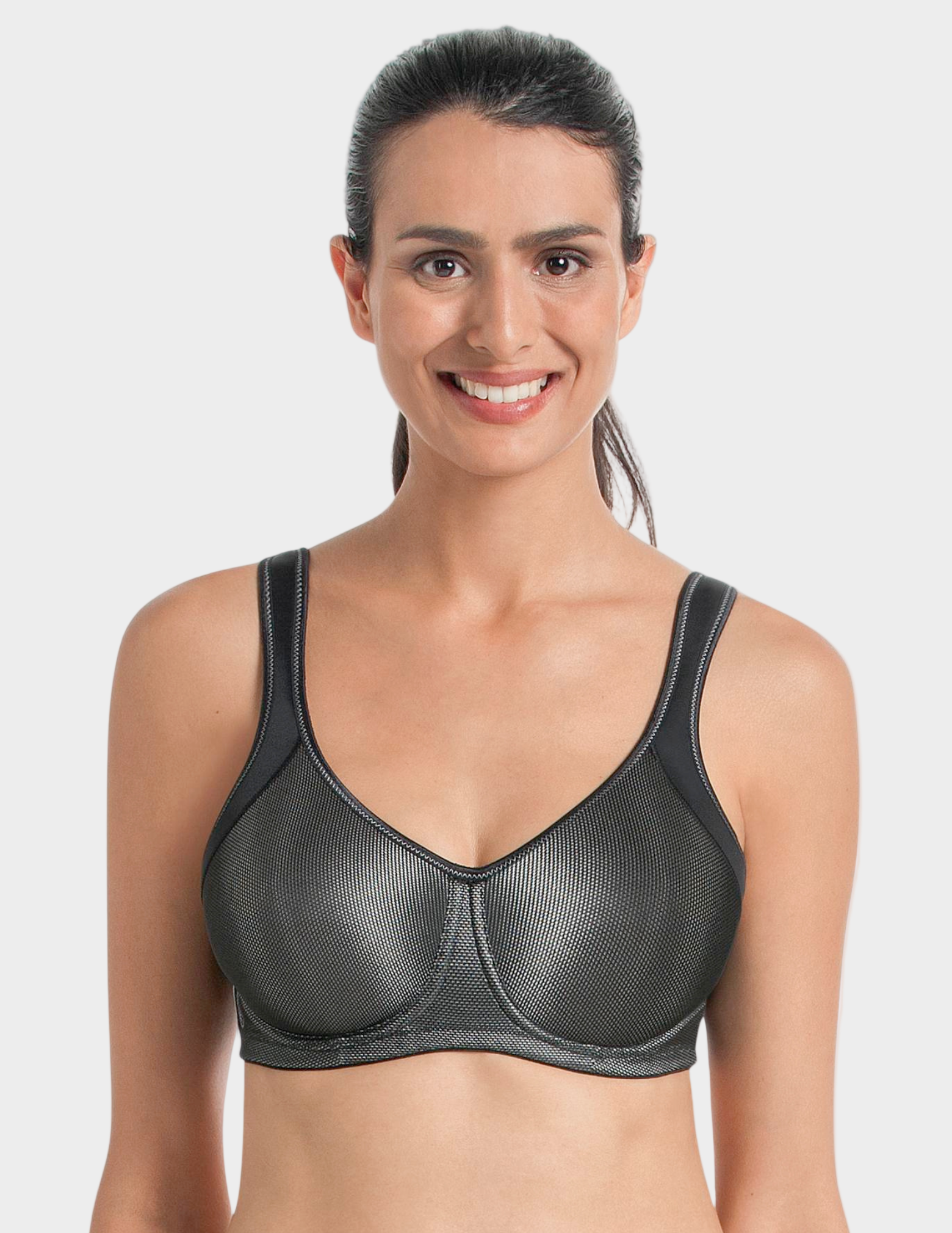 Woman wearing a black metallic sports bra against a white background