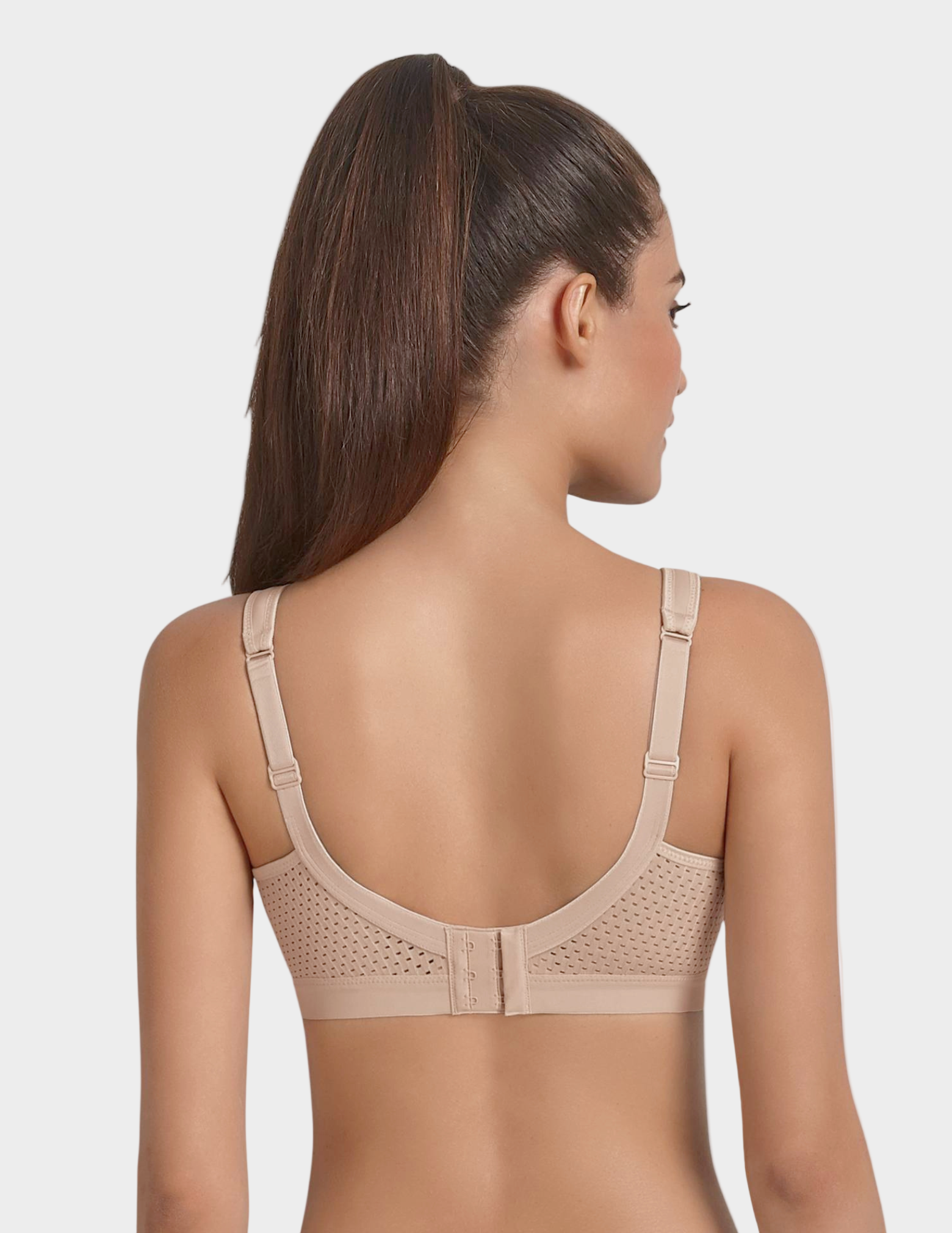 back view of Woman wearing a beige sports bra on a plain background