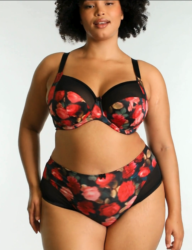 Model wearing bliss rose print bra and panty set turning and posing against a white background