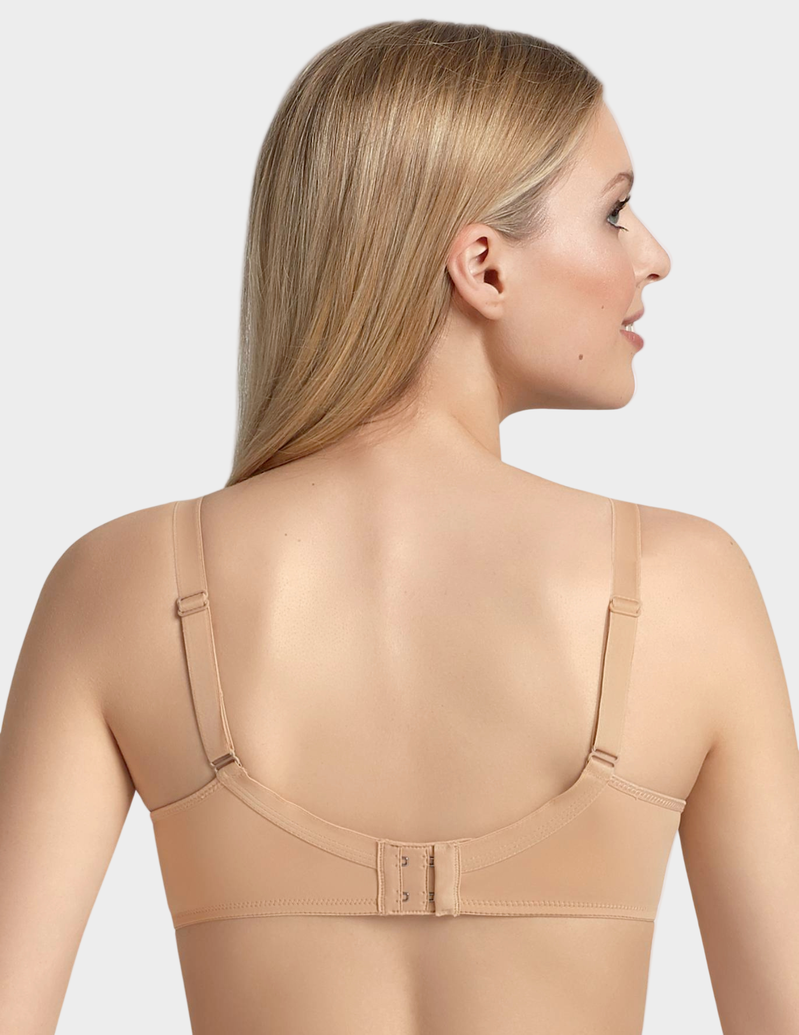 Woman wearing a beige bra on a white background