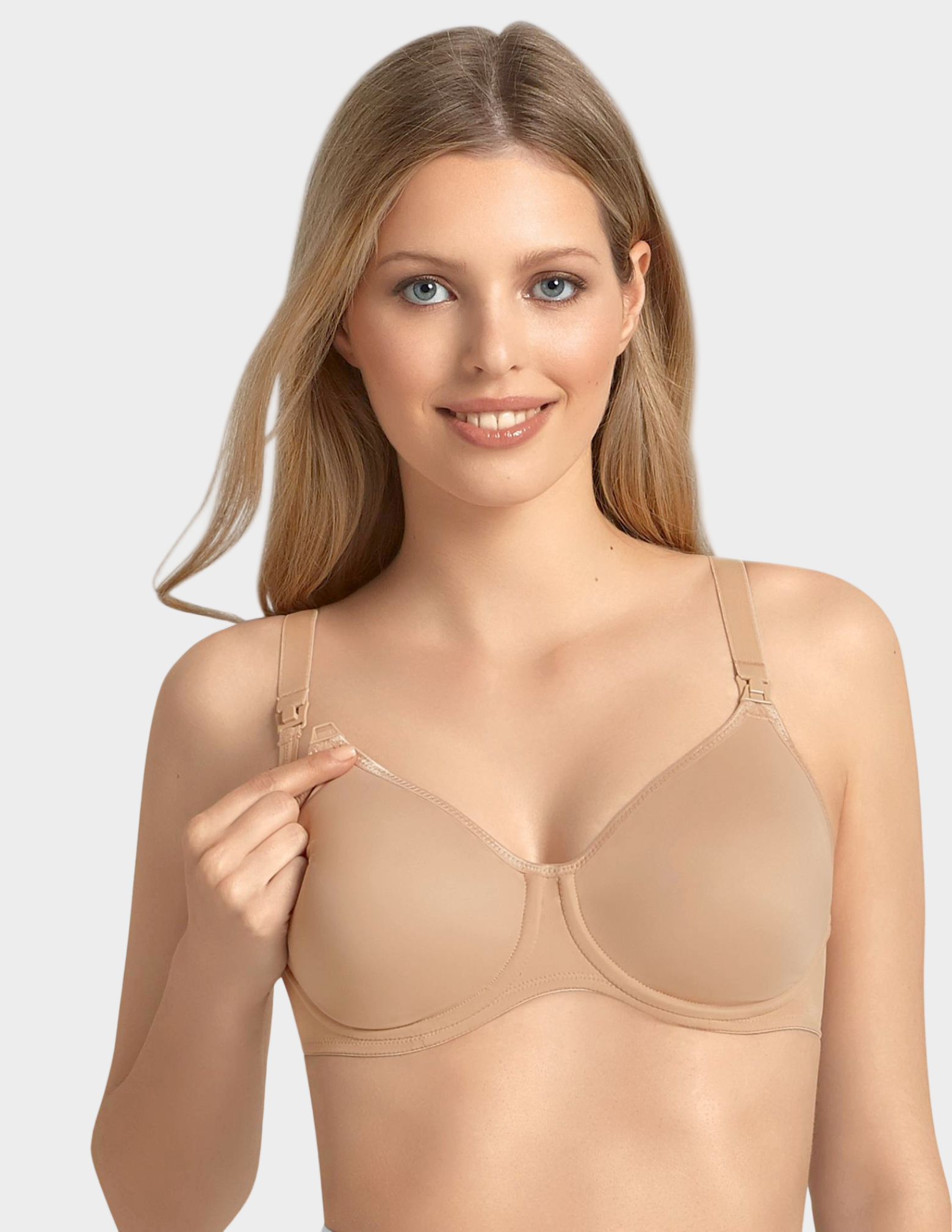 Woman wearing a beige nursing bra against a plain background