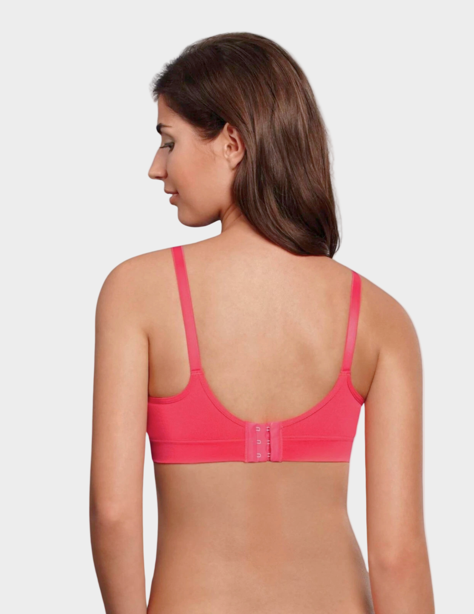 Woman wearing a pink bra on a white background