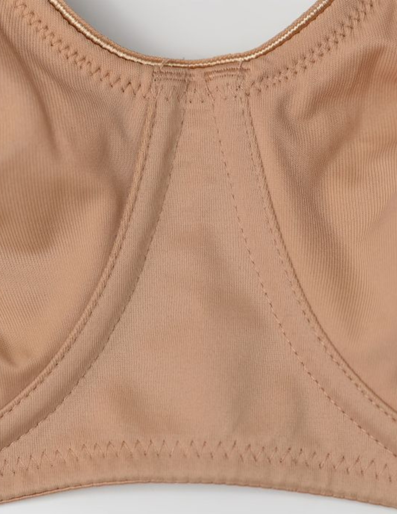 Close-up of a beige bra on a light gray background