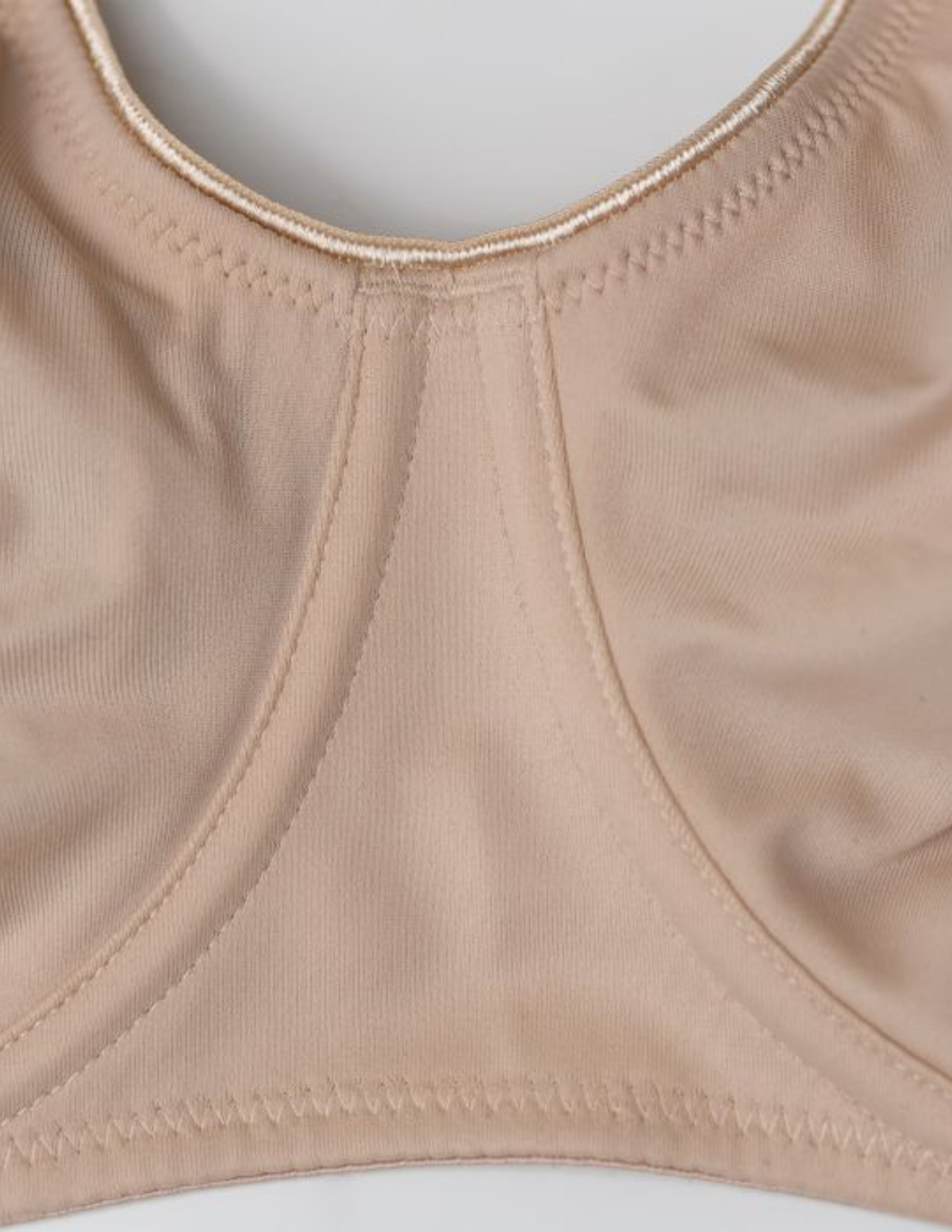Close-up of beige bra on a light gray background