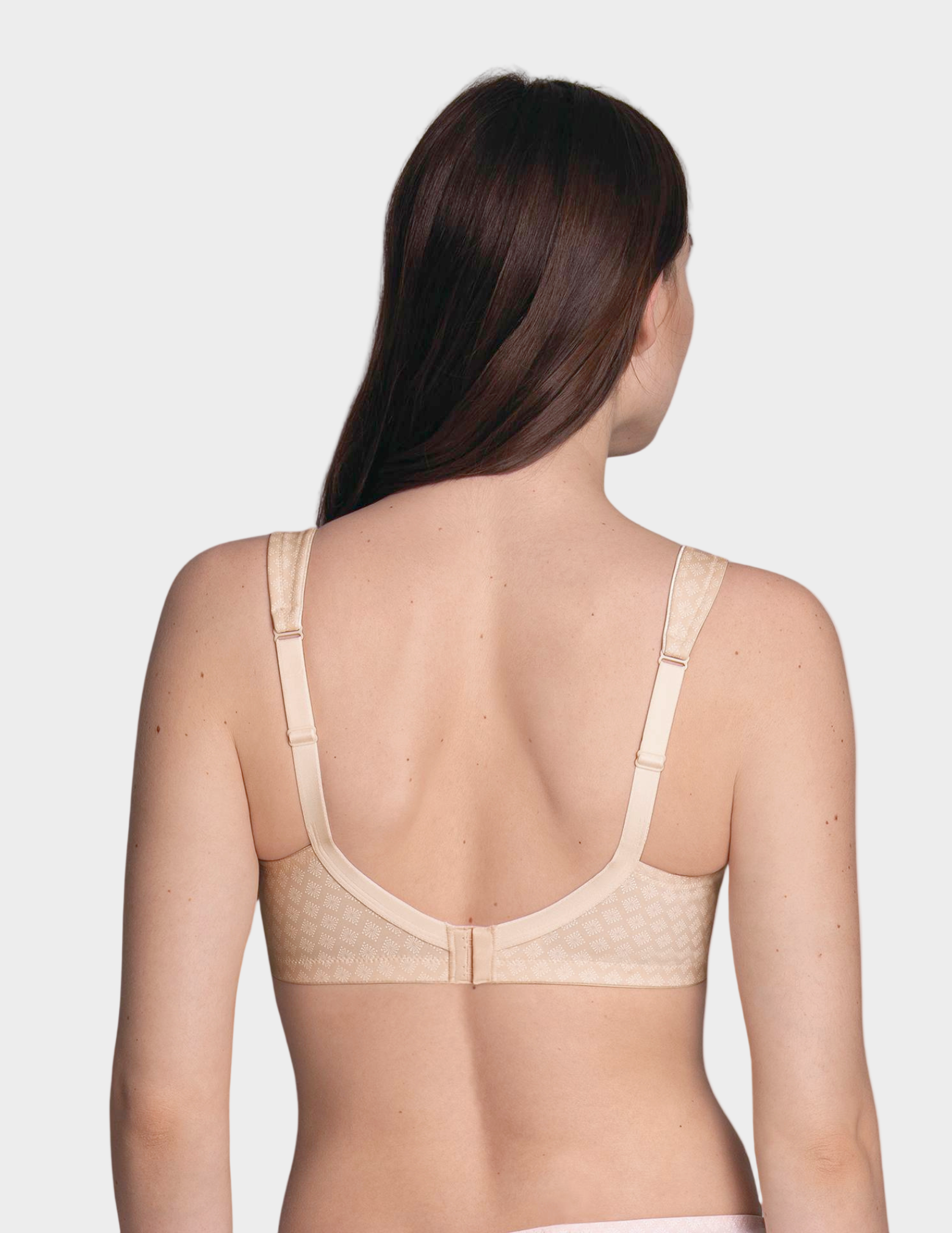 Beige bra worn by a model on a white background