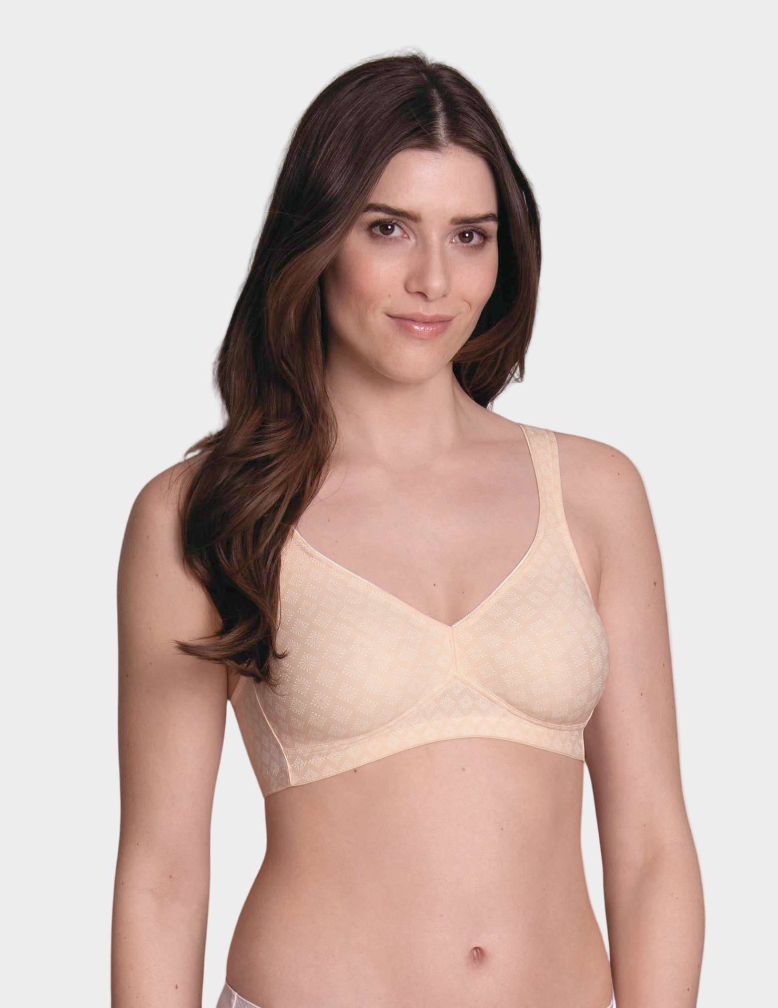 Woman wearing a beige bra on a white background