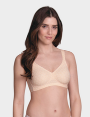 Woman wearing a beige bra on a white background