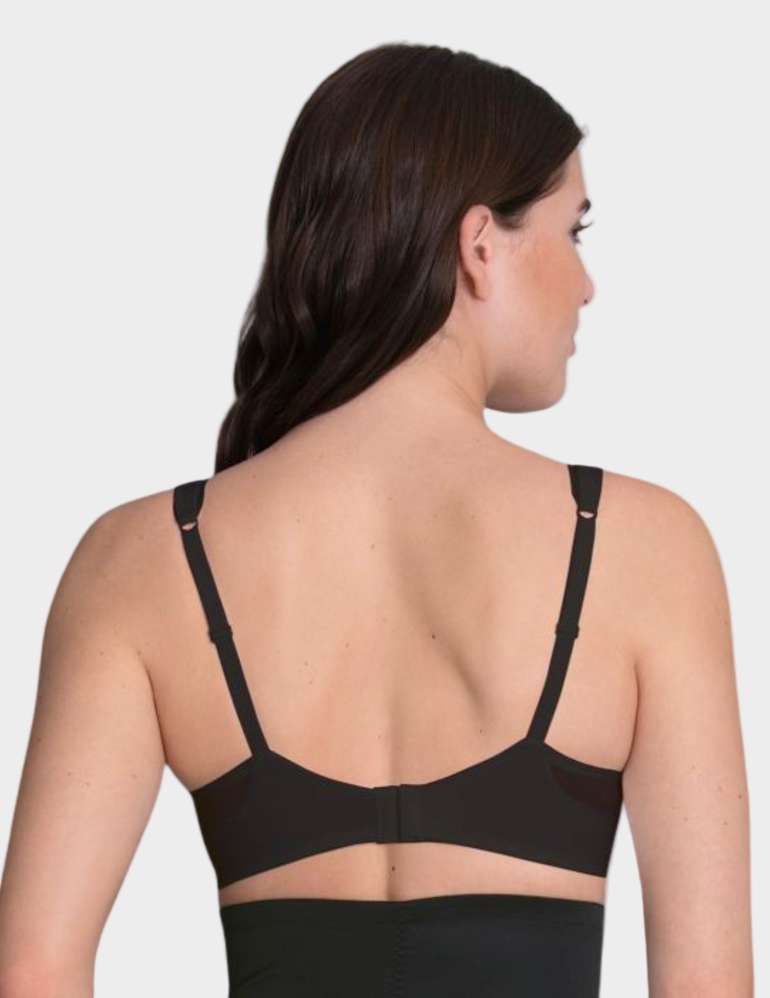 Woman wearing a black bra on a white background