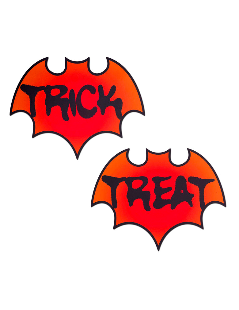 reddish orange bat shaped nipple covers, one says trick the other says treat in spooky black print