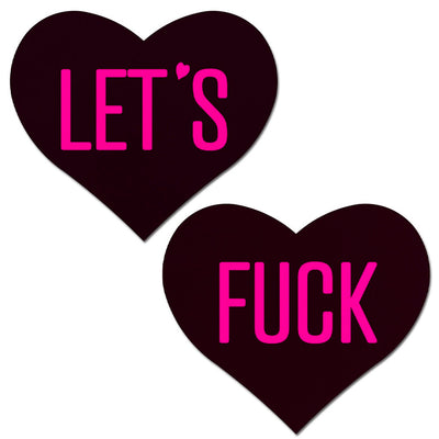 black heart shaped nipple covers with hot pink text "let's fuck"