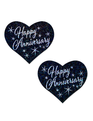 black heart shaped nipple covers with silver text "happy anniversary" on each, silver stars in background